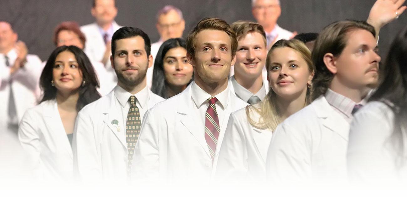 Medical students smile during their white coat ceremony